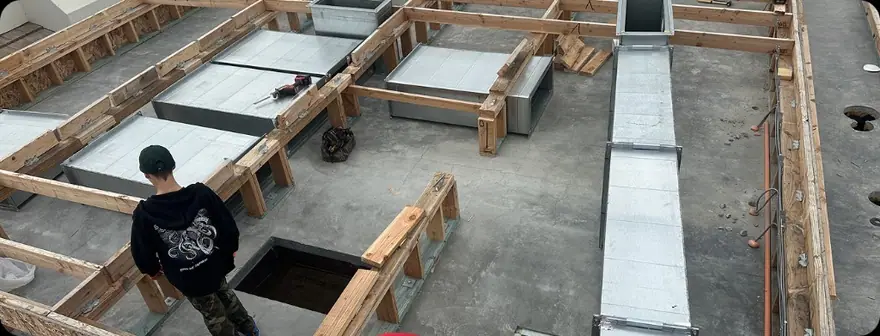 Ductwork installation on a residential roof structure